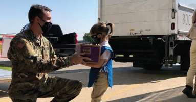 Planes Moving & Storage - Child giving a soldier a package