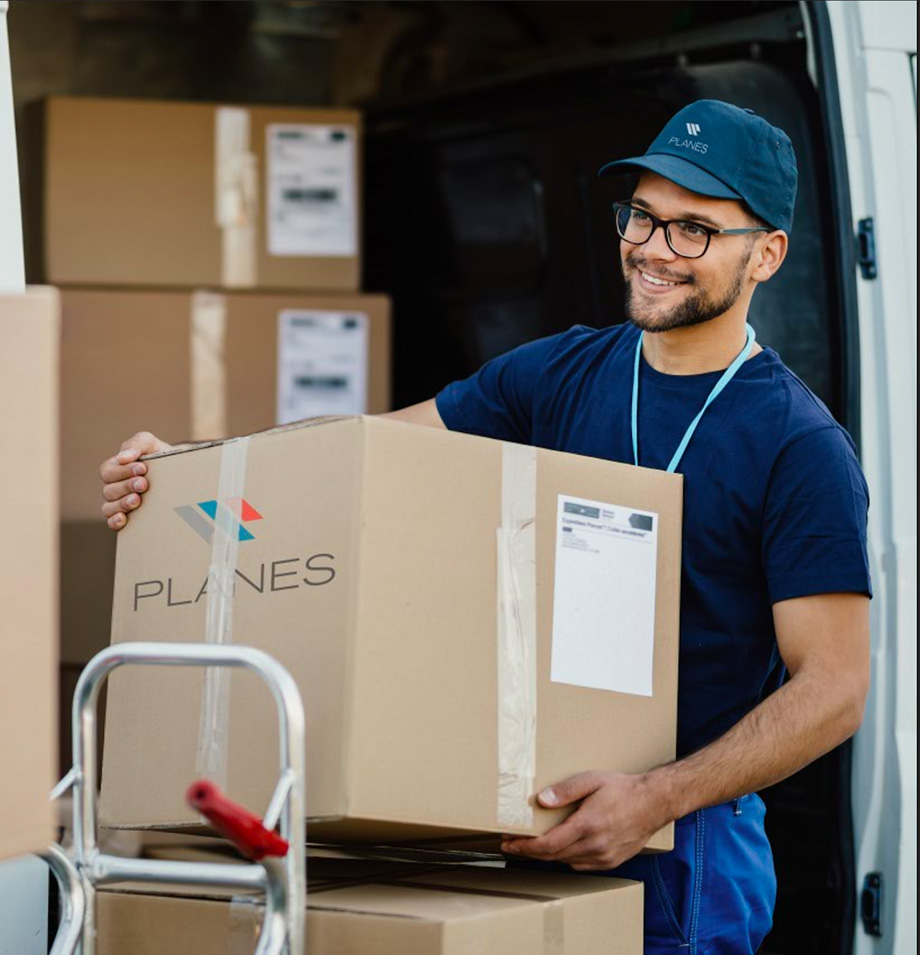 planes employee lifting a box