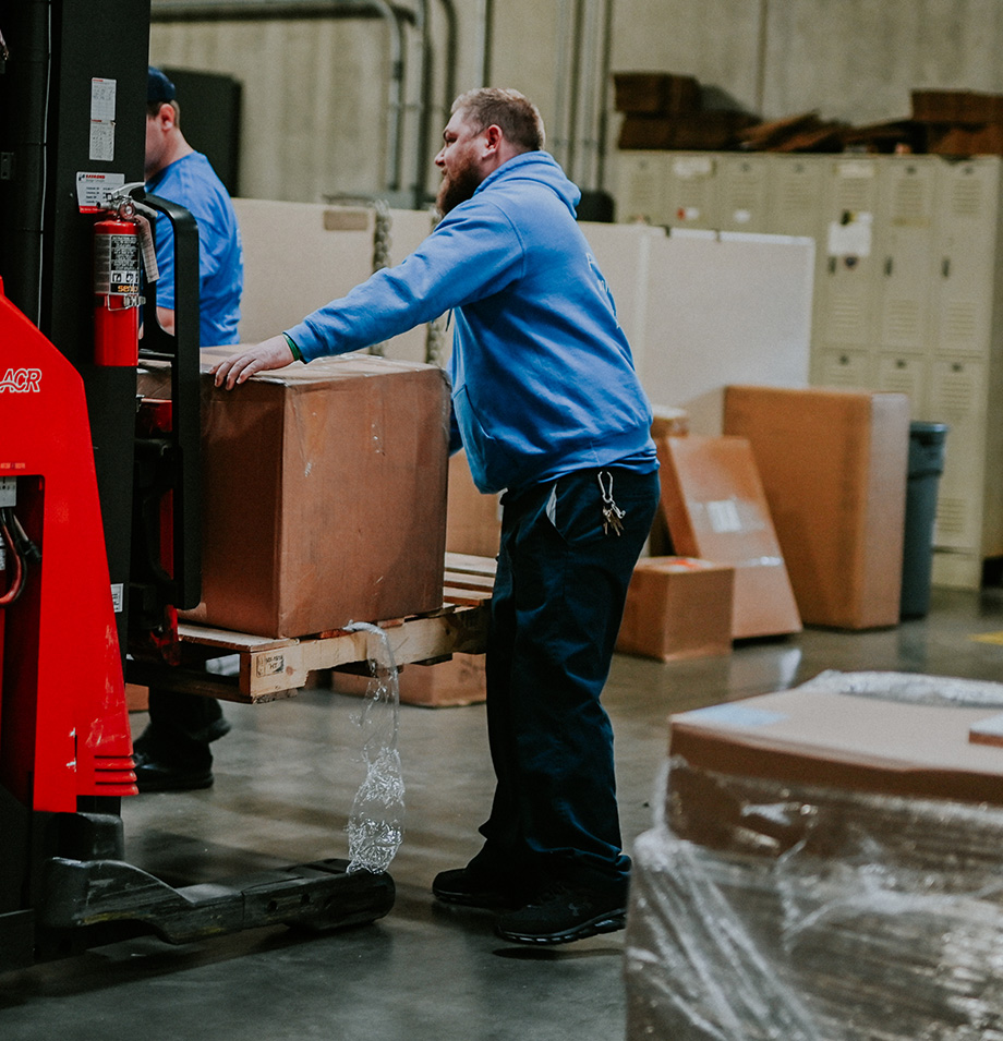 Planes employee stacking moving boxes